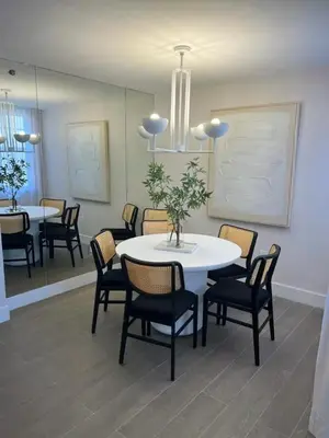 a dining room with a white table and chairs at The Yacht Club at Aventura Miami 4405 in Aventura