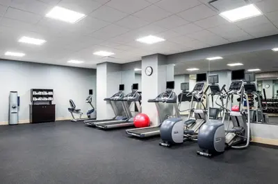 a gym with several treadmills and cardio machines at Homewood Suites by Hilton Miami Dolphin Mall in Miami