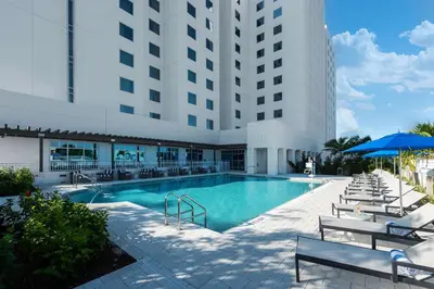 a swimming pool in front of a building at Homewood Suites by Hilton Miami Dolphin Mall in Miami
