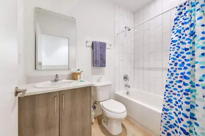 a bathroom with a toilet and a sink and a tub at Miami Townhouse Stay with Free Parking in Miami