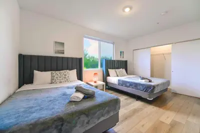 a bedroom with two beds and a large window at Miami Townhouse Stay with Free Parking in Miami