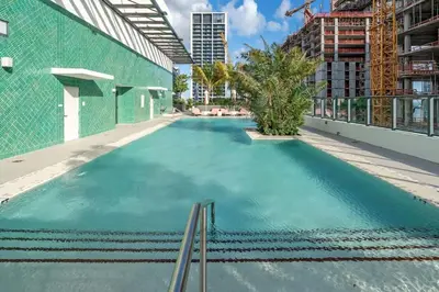 an empty swimming pool on the roof of a building at Corner Chic 2 Bedroom Downtown with Rooftop Pool & Views in Miami