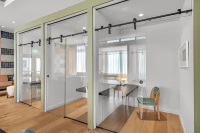 a room with glass doors and a table and a chair at Corner Chic 2 Bedroom Downtown with Rooftop Pool & Views in Miami