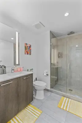 a bathroom with a shower and a toilet and a sink at Luxxe Suite Downtown Brickell in Miami