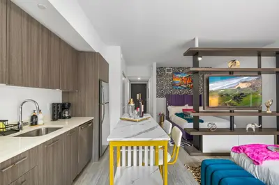a kitchen with a sink and a dining room at Luxxe Suite Downtown Brickell in Miami