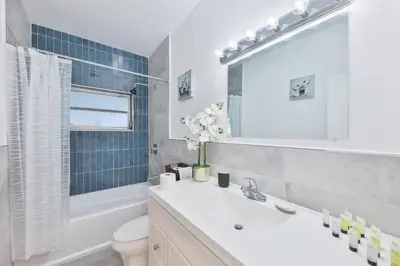 a white bathroom with a sink and a toilet at Aventura Ives Family Home in Miami