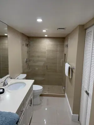 a bathroom with a shower and a toilet and a sink at The Yacht Club at Aventura Miami 3405 in South Island