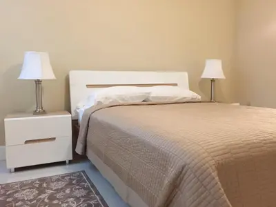 a bedroom with a bed with two night stands and two lamps at The Yacht Club at Aventura Miami 3405 in South Island