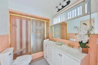 a bathroom with a toilet and a sink and a mirror at Family Grand Advantage in Hollywood