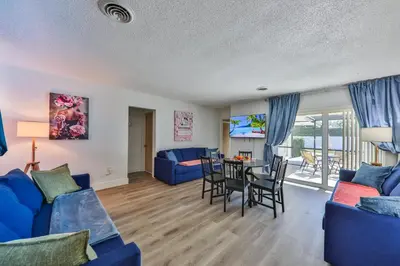a living room with a blue couch and a table at Family Grand Advantage in Hollywood