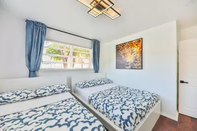 a bedroom with two beds and a window at Oasis of Love and Joy Family in Miami