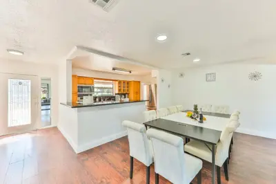 a kitchen and dining room with a table and chairs at Oasis of Love and Joy Family in Miami