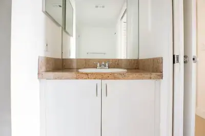 a bathroom with a sink and a mirror at The Yacht Club at Aventura Miami 6307 in South Island