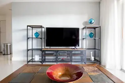 a living room with a television and a red bowl at The Yacht Club at Aventura Miami 6307 in South Island