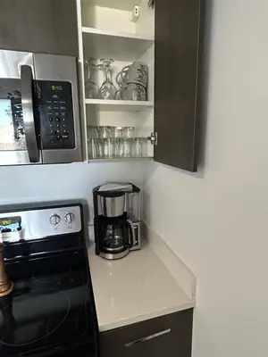 a kitchen with a microwave and a coffee maker at Miami-Brickell Skyline Luxury High Rise 2BR-2BATH - walking distance to KASEYA - HEAT ARENA - BAYSIDE - PORT OF MIAMI CRUISE SHIPS in Miami