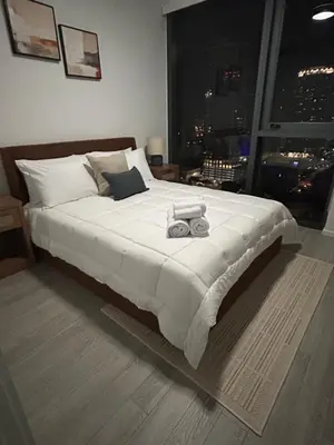 a bedroom with a large white bed with a window at Miami-Brickell Skyline Luxury High Rise 2BR-2BATH - walking distance to KASEYA - HEAT ARENA - BAYSIDE - PORT OF MIAMI CRUISE SHIPS in Miami