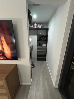 a hallway leading to a room with a stove and a tv at Miami-Brickell Skyline Luxury High Rise 2BR-2BATH - walking distance to KASEYA - HEAT ARENA - BAYSIDE - PORT OF MIAMI CRUISE SHIPS in Miami