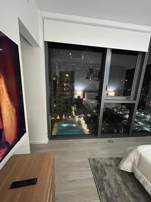 a bedroom with a large window with a view of a city at Miami-Brickell Skyline Luxury High Rise 2BR-2BATH - walking distance to KASEYA - HEAT ARENA - BAYSIDE - PORT OF MIAMI CRUISE SHIPS in Miami