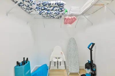 a room with a rack of cleaning supplies on a wall at Family Poolside Palm Retreat with Jacuzzi in Hollywood