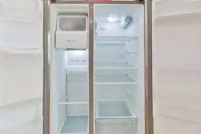 an empty refrigerator with its door open and its shelves at Family Poolside Palm Retreat with Jacuzzi in Hollywood