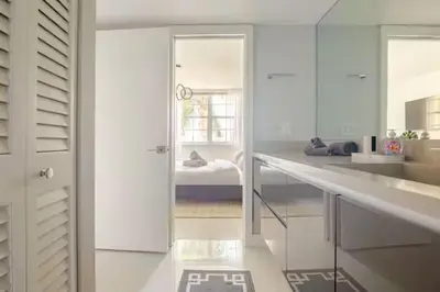 a white kitchen with white cabinets and a sink at The Yacht Club at Aventura Miami 9505 in South Island