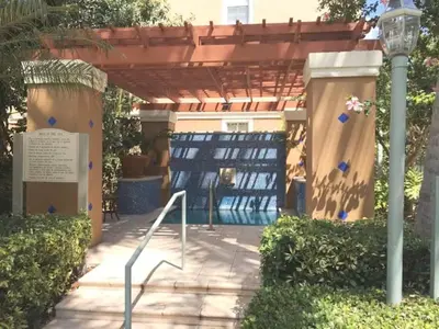 a pergola with a gate and a sign and a light at The Yacht Club at Aventura Miami 9505 in South Island
