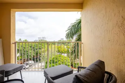 a room with a balcony with a large window at The Yacht Club at Aventura Miami 9505 in South Island
