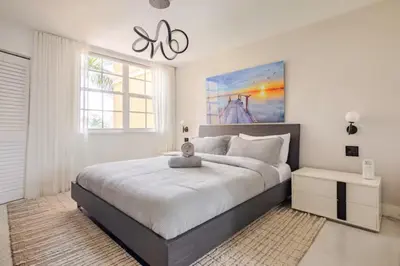 a white bedroom with a large bed and a window at The Yacht Club at Aventura Miami 9505 in South Island