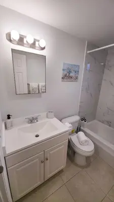a bathroom with a sink and a toilet and a tub at Apartment close to shops & beach-Free Parking 109 in Hollywood