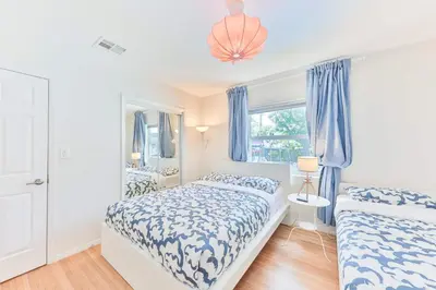 two beds in a bedroom with blue and white at Heart of Hollywood Villa in Hollywood