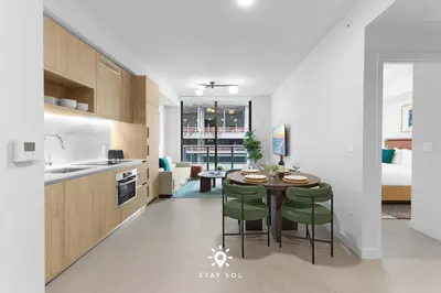 a kitchen and dining room with a table and chairs at Stylish 1BR Apt With Pool in Miami