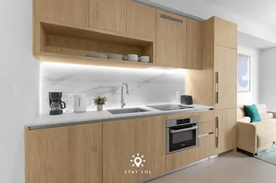 a kitchen with wooden cabinets and a sink at Stylish 1BR Apt With Pool in Miami