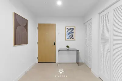 a hallway with a door and a table in it at Stylish 1BR Apt With Pool in Miami