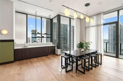 a kitchen with a table and a tub and some windows at Stylish 1BR Apt With Pool in Miami