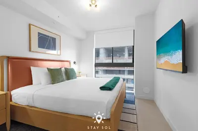 a bedroom with a large bed and a window at Stylish City Retreat With Private Balcony in Miami