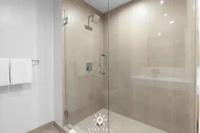 a shower with a glass door in a bathroom at Stylish City Retreat With Private Balcony in Miami