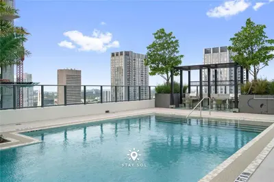 a swimming pool on the roof of a building at Stylish City Retreat With Private Balcony in Miami