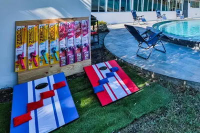 a pool with a table and chairs next to a pool at 50 Shades of Grey on the Canal Villa STR-4500 in Fort Lauderdale