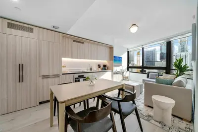 a kitchen and living room with a table and chairs at Downtown Edit-Resort Style Stay with Full Amenities in Miami