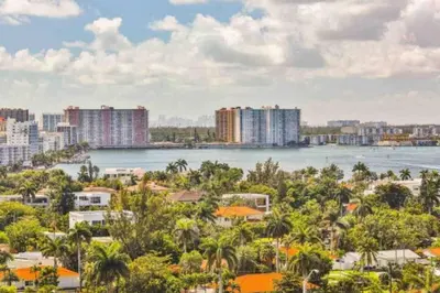 a cityscape of a city with a river and buildings at Condo with Stunning View STR-01307 in Sunny Isles Beach