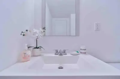 a white bathroom with a sink and a mirror at Condo with Stunning View STR-01307 in Sunny Isles Beach