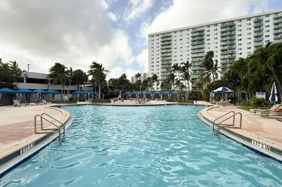 a large swimming pool in front of a large building at Condo with Stunning View STR-01307 in Sunny Isles Beach