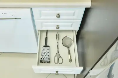 a white cabinet with utensils in it at Family getaway steps from the ocean STR-01305 in Sunny Isles Beach