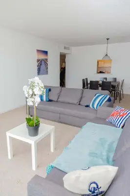 a living room with a gray couch and a table at Condo on the Beach-STR 01309 in Sunny Isles Beach