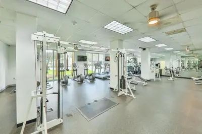 a gym with several treadmills and machines at Condo on the Beach-STR 01309 in Sunny Isles Beach