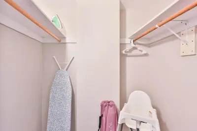 a room with white walls and a rack of clothes at Ocean reserve 1st floor across the beach STR-02382 in Sunny Isles Beach