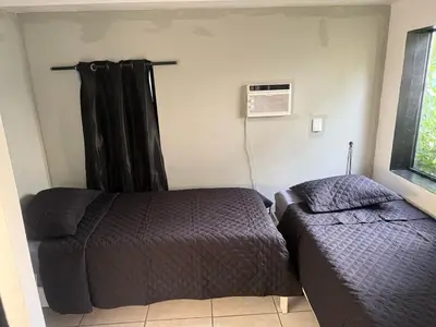 a bedroom with two beds and a window at paradise in North Miami Beach