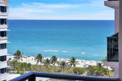 a view of the beach from the balcony of a building at Beachfront Luxury Alexander Unit, Pool Gym Parking in Miami Beach