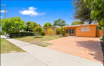 an orange house with a driveway at Private King Master Suite Near Hardrock Stadium in Miami Gardens