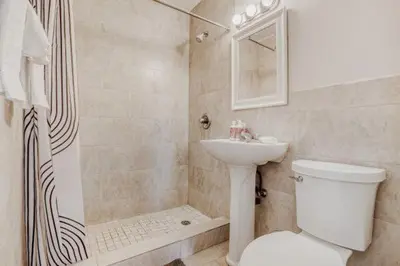 a bathroom with a toilet and a sink and a shower at Lauderdale Breeze Villas - Coastal 2 Bedroom in Fort Lauderdale
